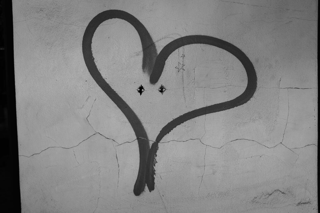 Spray painted heart with eyes and star on it.